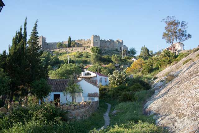 The Castle of Castellar is surrounded by vegetation.